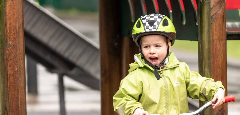 Child-On-Bicycle-Playing-In-A-Park